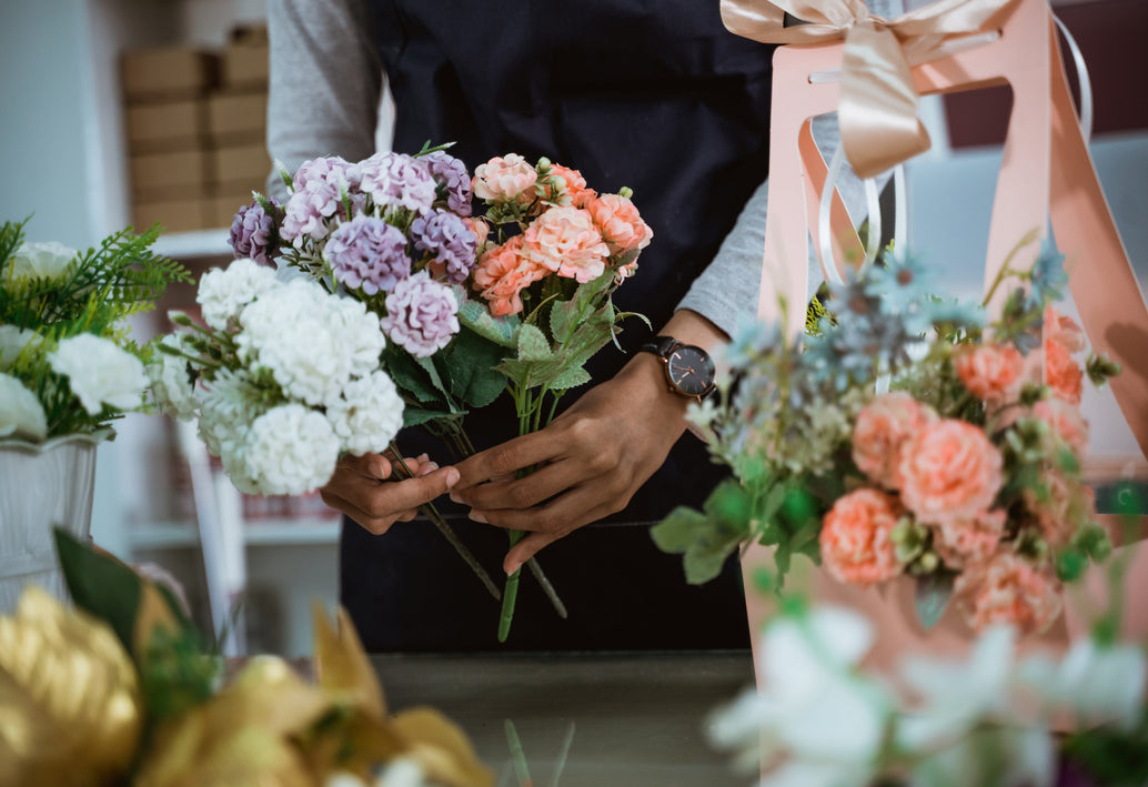 Florist arranging elegant bouquets of roses and hydrangeas at Allan Woods Flowers in Washington DC